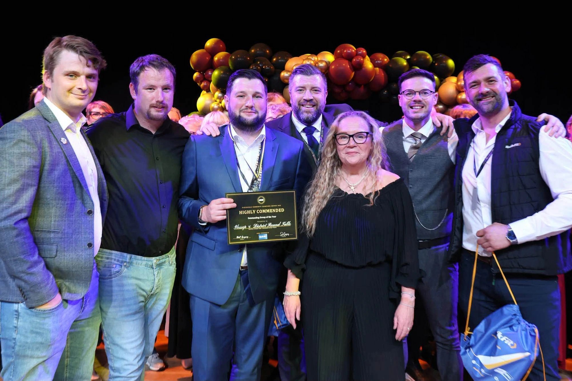 Round Table members on stage holding the Highly Commended certificate for Outstanding Group of the Year at the Glossopdale Community Champions Awards 2026